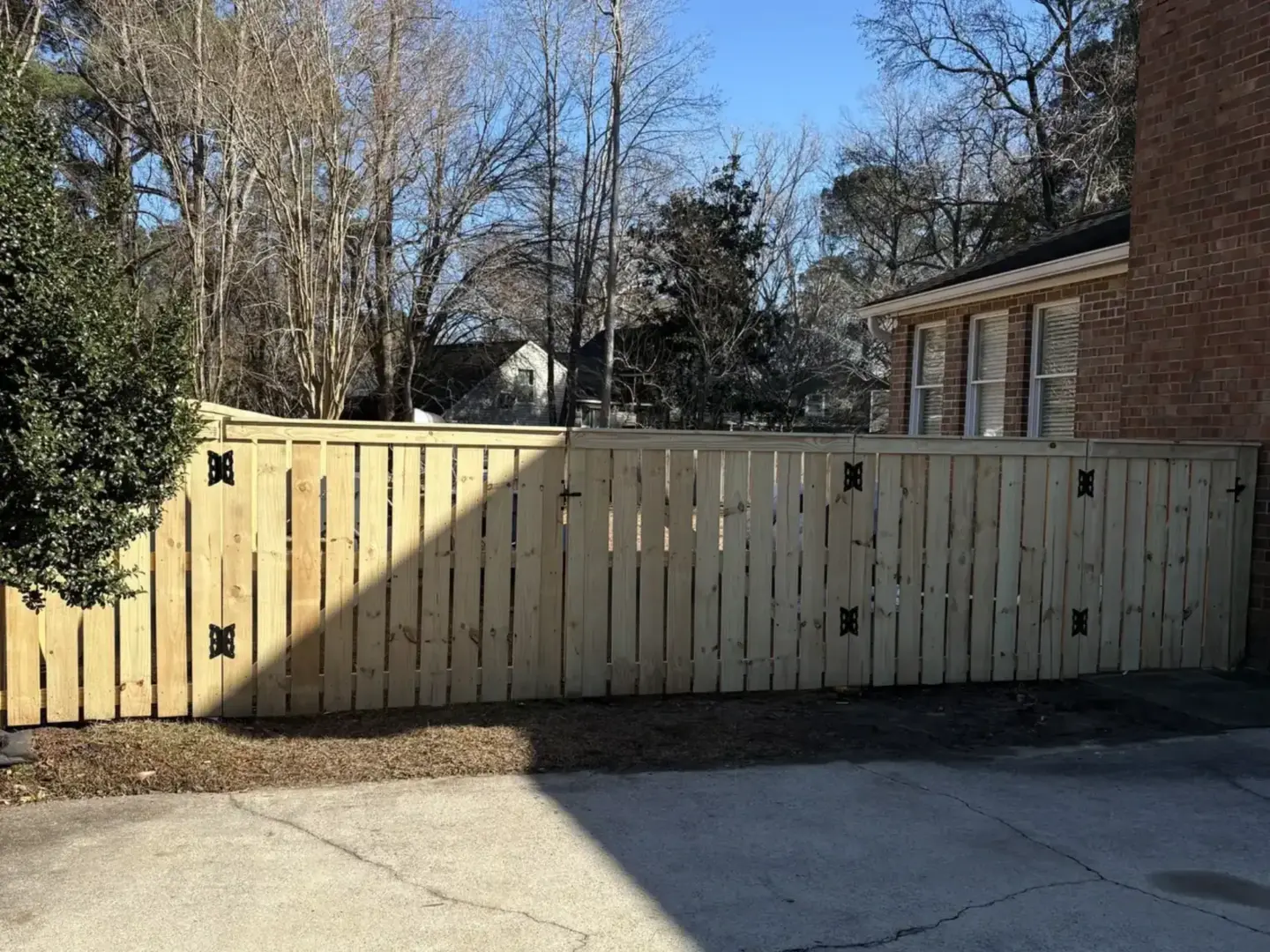 semi privacy fence on the brick house featuring tall trees in charleston sc 1440x1080