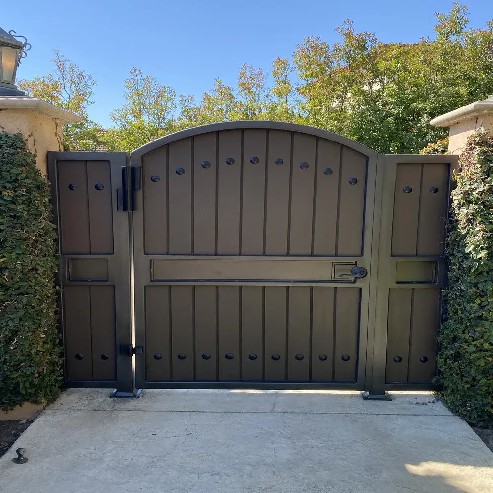 Sk brown metal gate with tree in background