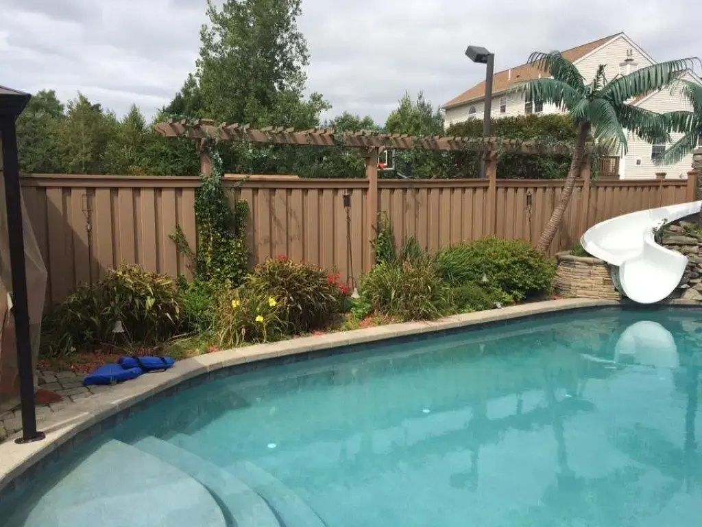 Sk trex seclusions fencing with arbor next to pool