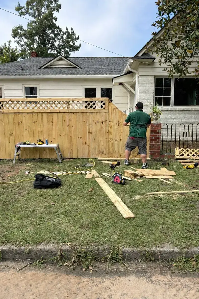 Wooden privacy fence with design on top and carolina fence company installation in charleston sc